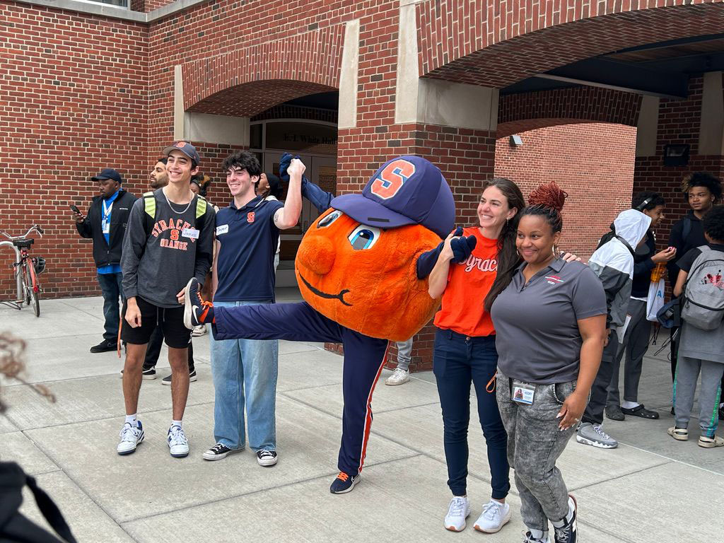 Utica students pose with Otto outside of Falk college