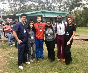 A group of students pose in a field