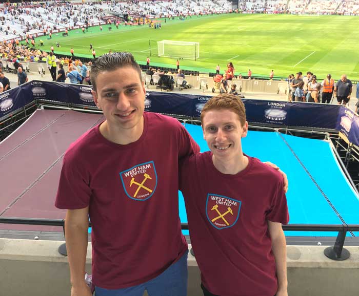 Students Justin Perline and CB Garrett pose in stadium