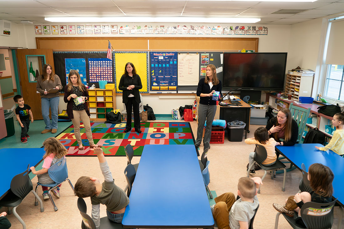Teachers in the front of a classroom of pre-k students