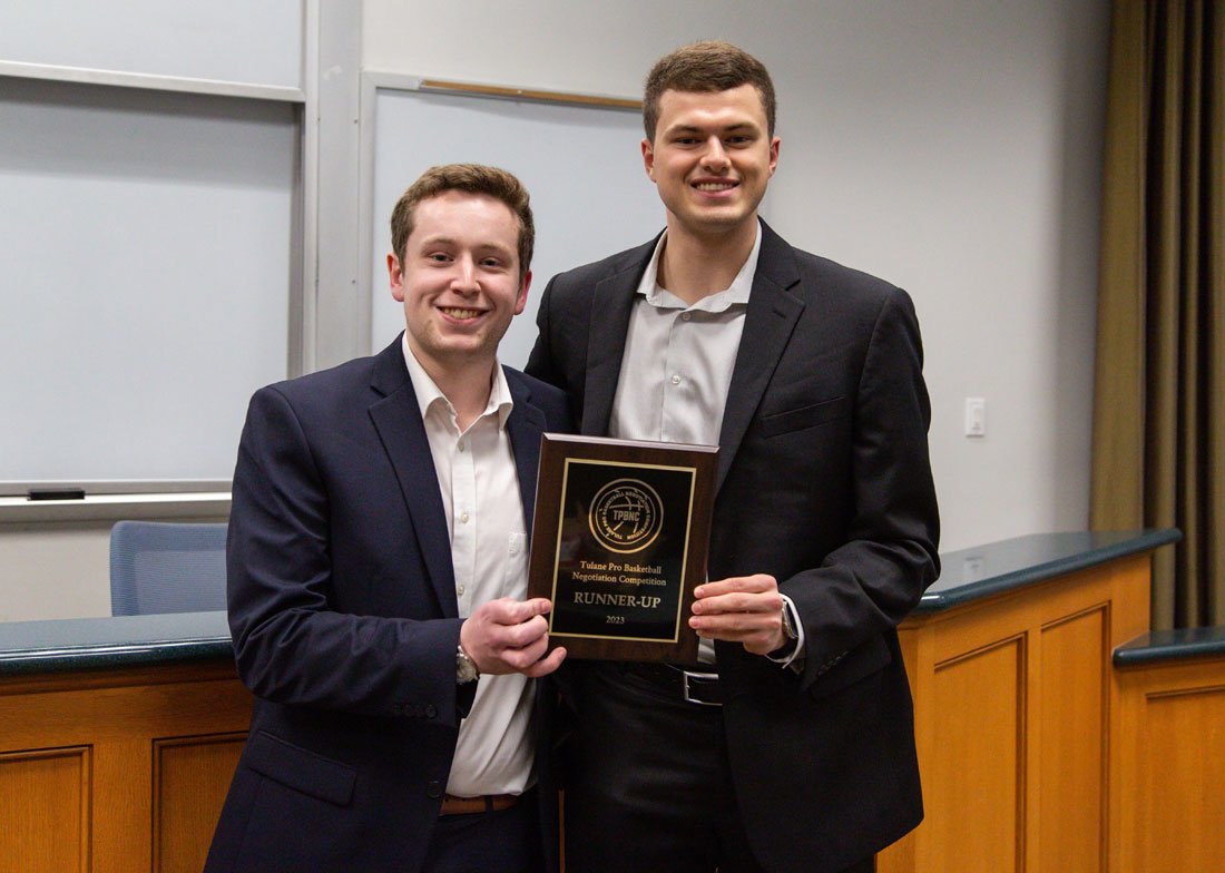 Preston and Jackson are posed holding a plaque together.