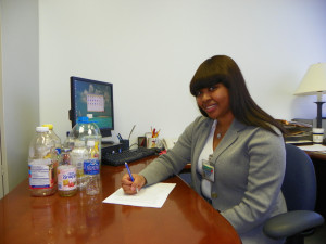 Shanique Campbell sits at research desk with various drink bottles
