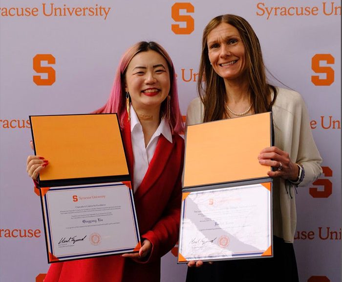 Liu and Razza holding award certificates