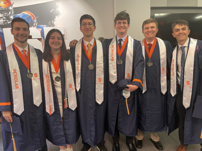 6 Persons are posed in graduation gowns