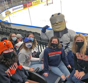 A group poses in a NHL stadium
