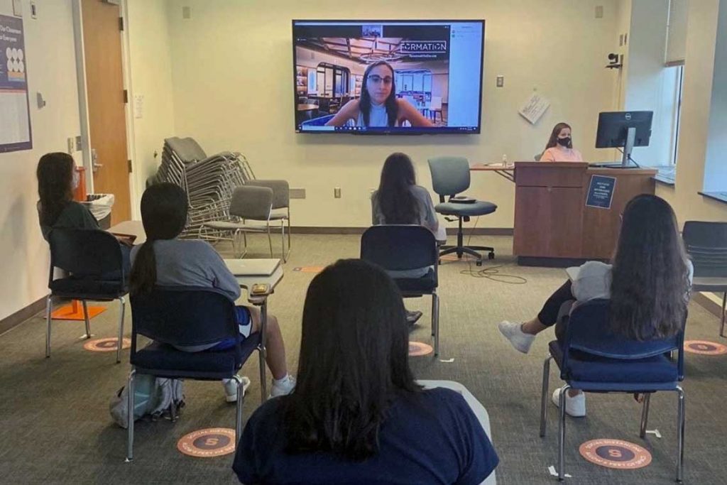 women are seated away from each other in a Zoom session