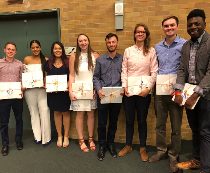 group of students pose with awards