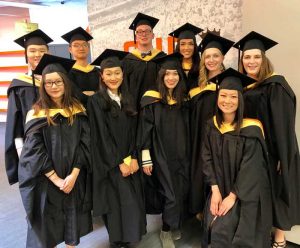 Students pose in cap and gown