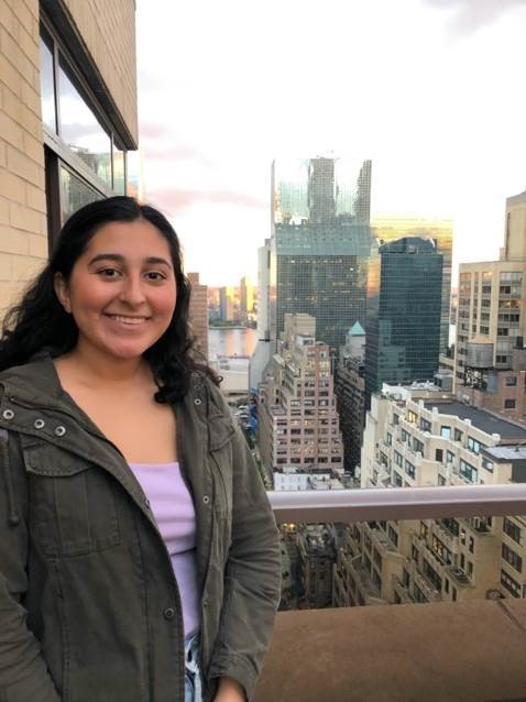 Salma Silvas poses in front of a cityscape