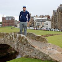 Sam Staton poses on a bridge on a golf course