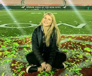 Sarah Incerpi sits on a field