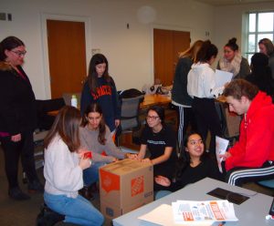 Social Work students assemble donation boxes for the 2018 food drive.