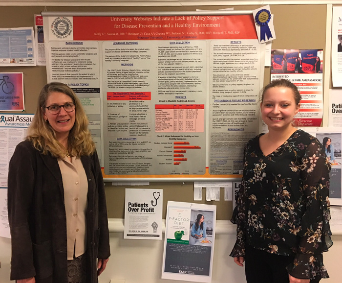 Tanya Horacek stands with Natasha Jackson in front of her winning research poster