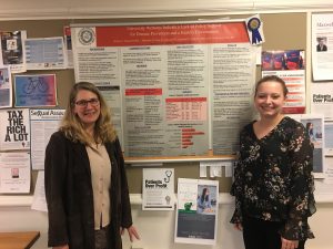 Tanya Horecek and Natasha Jackson stand next to a research poster