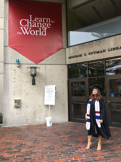 Thalia Henao stands outside a building at Harvard University