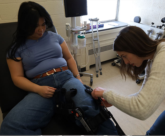 attaching leg brace to student