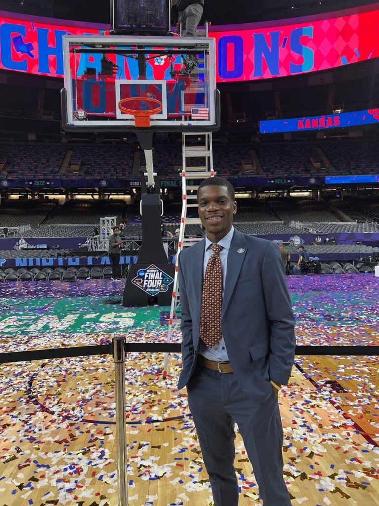 Tobi poses on a basketball court after a game