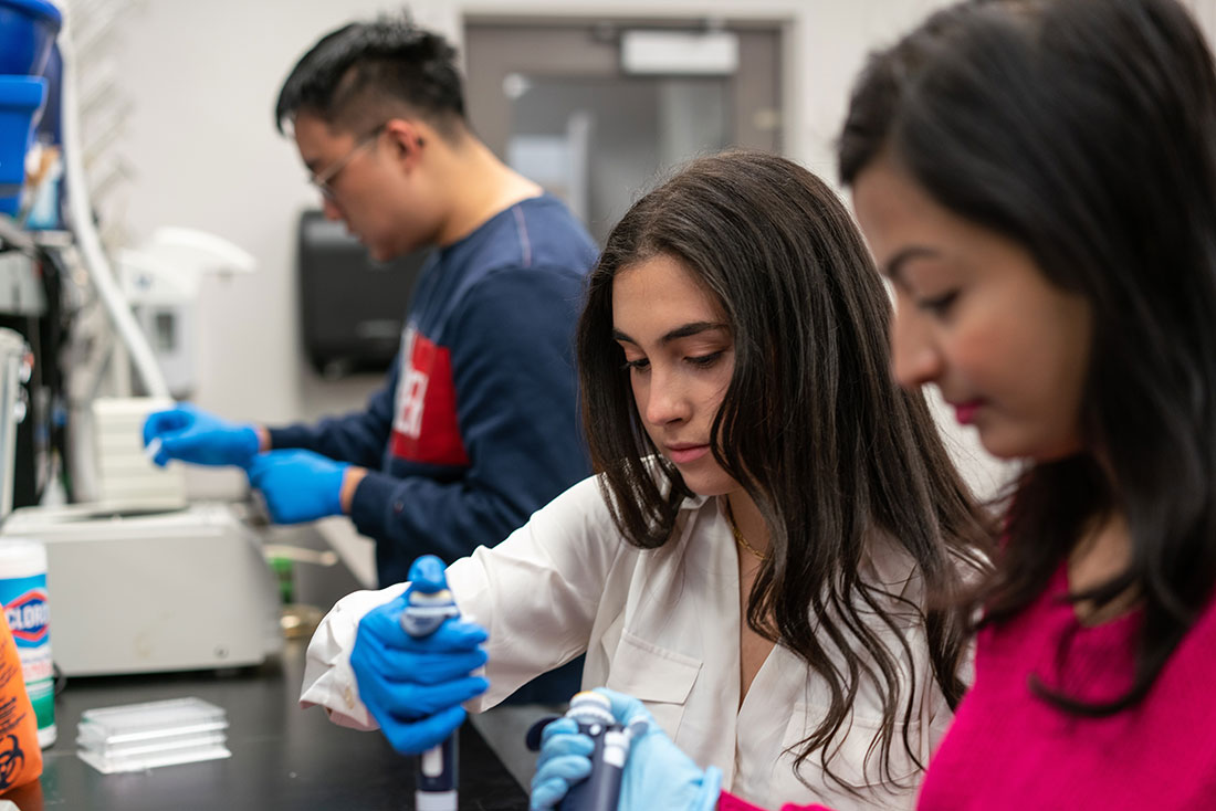 Two women ad one man working in a lab