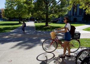 SU student on the Quad with bike