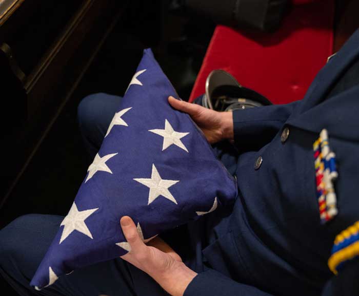 Decorated veteran holds a folded flag