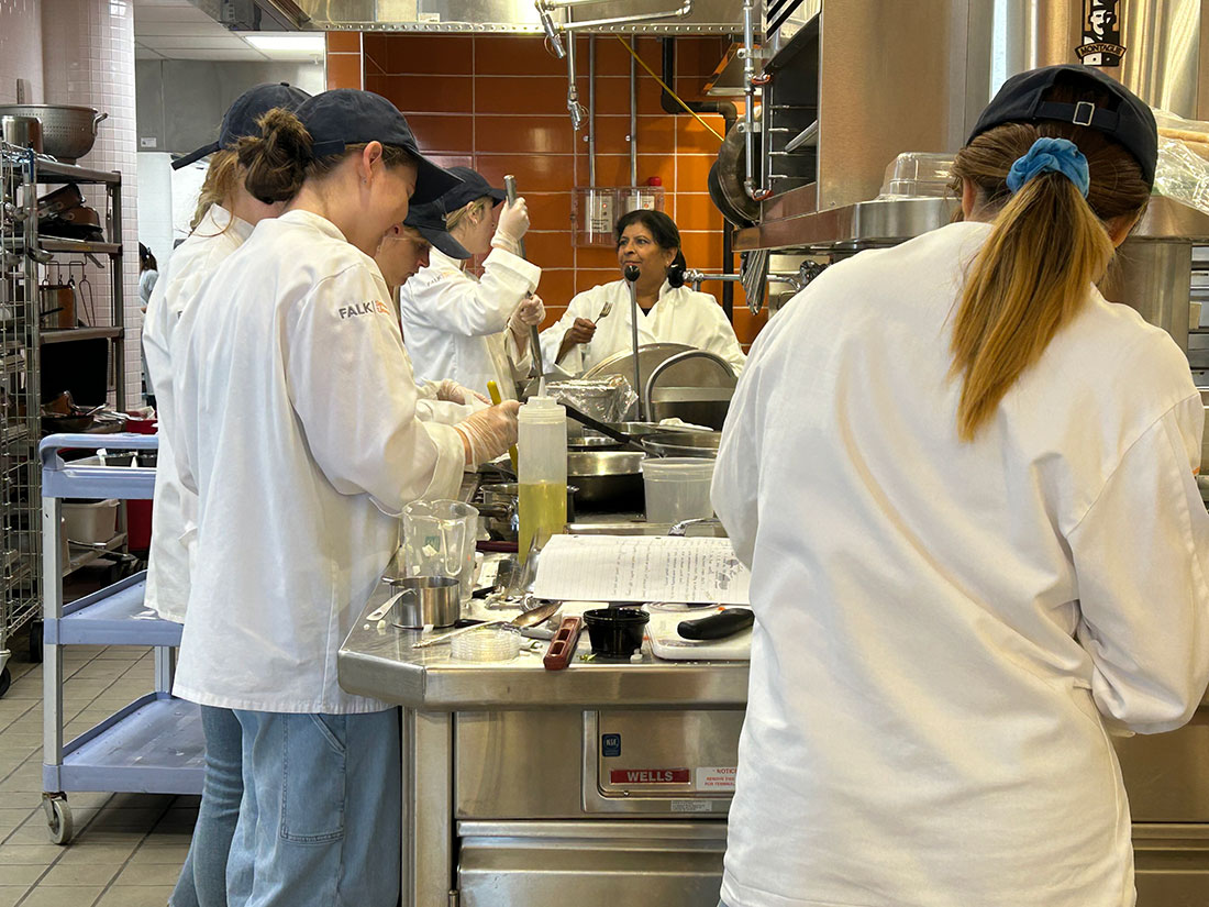 Six students working in Klenk Kitchen, Falk College with Chef Gadia