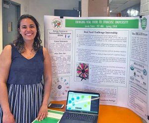 Avery Zainab Pixler stands next to her research poster