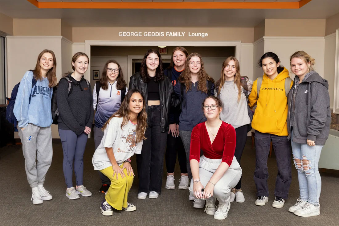 A group of 11 women are posed together.