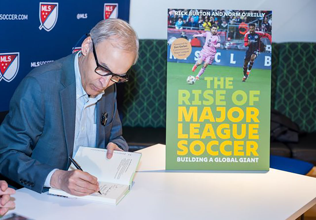Rick Burton signing his book at book launch event