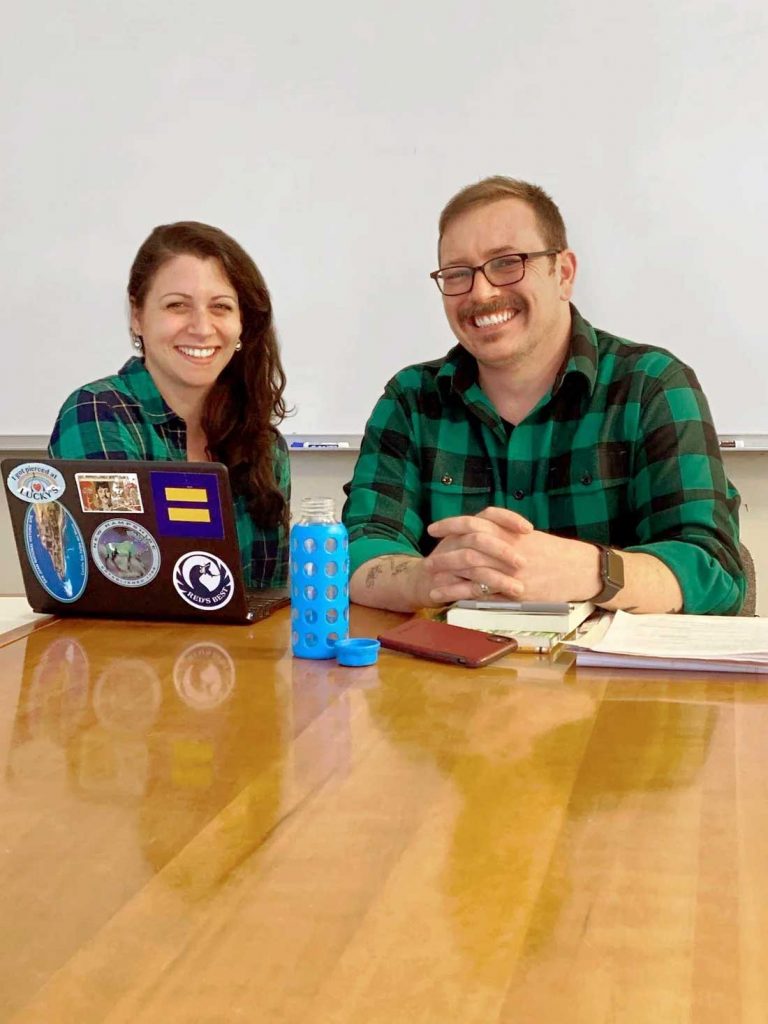 A professor and a student sit side by side