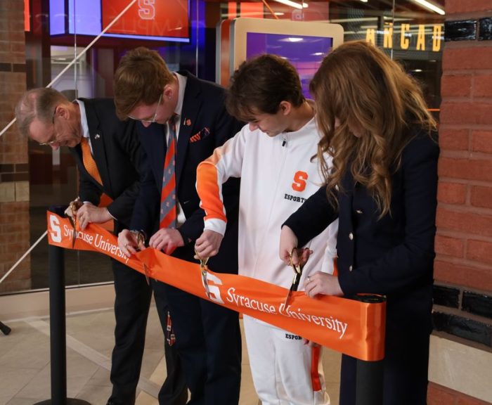 Four people cutting ribbon at grand opening