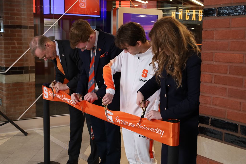 Four people cutting ribbon at grand opening