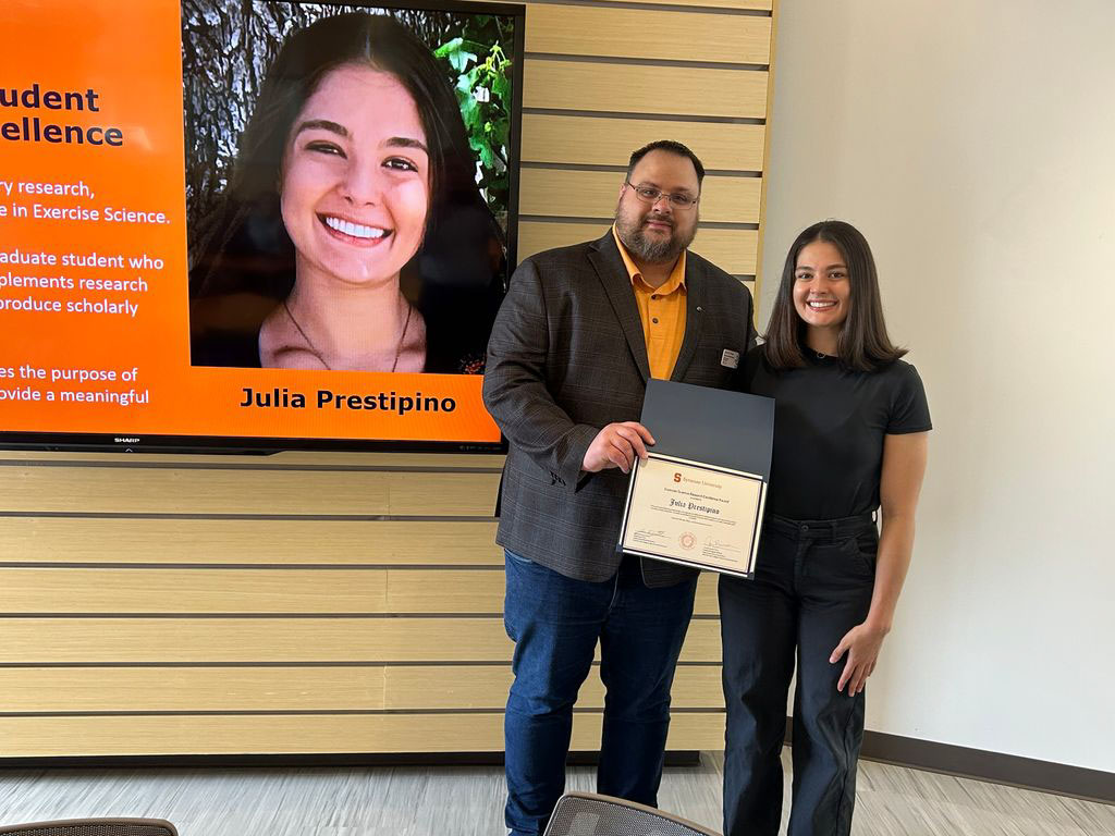 Student Julia Prestipino accepting award from Exercise Science Department Chair Jason DeFReitas