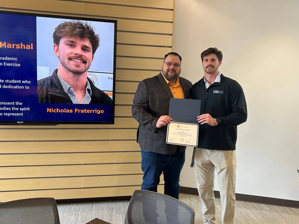 Student Nicholas Fraterrigo accepting award from Exercise Science Department Chair Jason DeFReitas