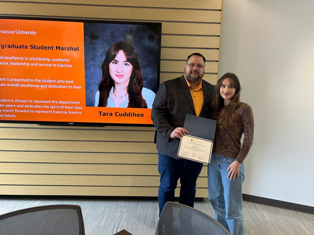 Student Tara Cuddihee accepting award from Exercise Science Department Chair Jason DeFReitas