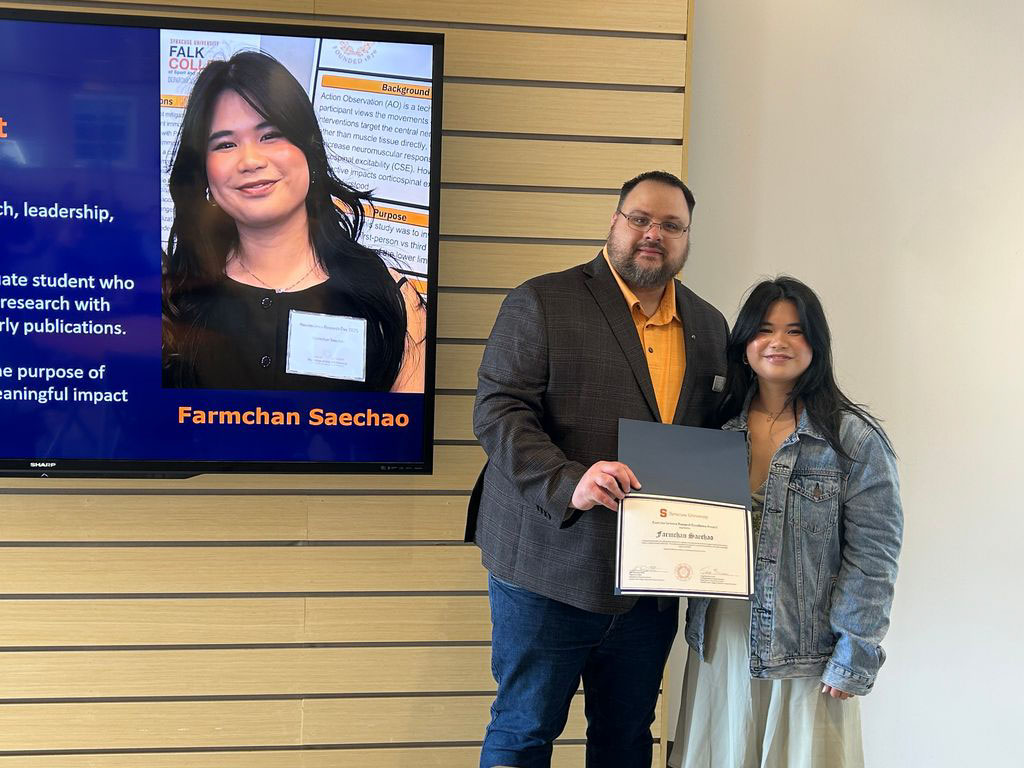 Student Farmchan Saecho accepting award from Exercise Science Department Chair Jason DeFReitas
