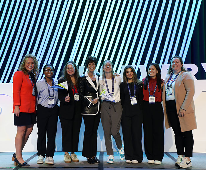 8 young women standing together