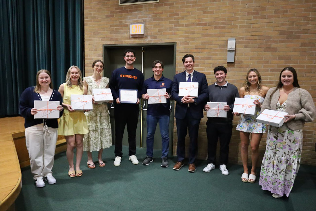 Students who received awards from sport management are standing together in a line in the front of Grant Auditorium