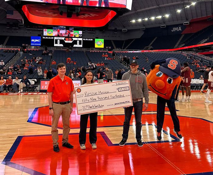 rescue mission charity check being presented by Otto and friends on the basketball court