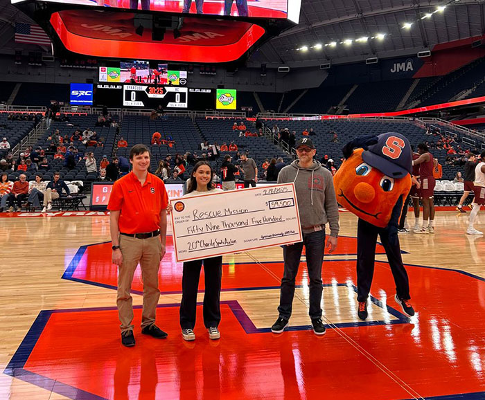 rescue mission charity check being presented by Otto and friends on the basketball court