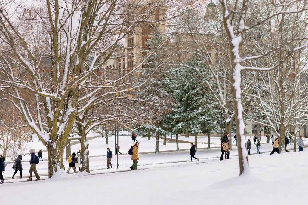 students walking across a winter landscape on the SU campus